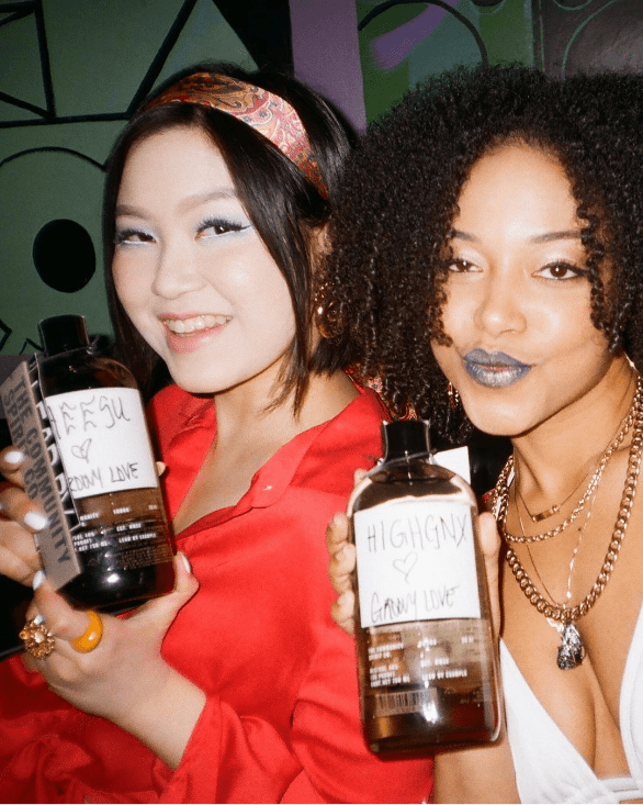 2 ladies holding the community spirits bottle